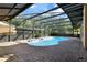 Inviting screened pool area with brick pavers at 2711 Ambrosia Ct, Apopka, FL 32703