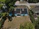 Aerial view of the property with solar panels and mature trees at 5018 Figwood Ln, Orlando, FL 32808