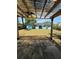 View of the backyard from under the covered patio, showing solar panels on the house at 5018 Figwood Ln, Orlando, FL 32808