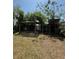 Backyard features a covered patio and additional storage, providing versatile outdoor space at 5018 Figwood Ln, Orlando, FL 32808