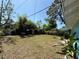 Spacious backyard with a covered patio area, perfect for relaxation and outdoor enjoyment at 5018 Figwood Ln, Orlando, FL 32808