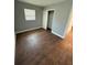 This bedroom features wood-look tile flooring and a closet for ample storage at 5018 Figwood Ln, Orlando, FL 32808