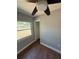 Bedroom featuring wood-look tile flooring, neutral paint, window and closet at 5018 Figwood Ln, Orlando, FL 32808