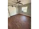 This bedroom features modern ceiling fan and barn door closet access at 5018 Figwood Ln, Orlando, FL 32808