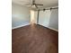 This bedroom has barn door access to a closet and wood-look tile floors at 5018 Figwood Ln, Orlando, FL 32808