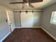 This bedroom has barn door access to the closet, wood-look tile flooring, and ceiling fan at 5018 Figwood Ln, Orlando, FL 32808