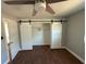 This bedroom features barn door closet access with an open closet and wood-look flooring at 5018 Figwood Ln, Orlando, FL 32808
