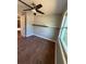 Bedroom features wood-look floors, a ceiling fan, a neutral color palette, and a floating shelf at 5018 Figwood Ln, Orlando, FL 32808