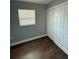 Cozy bedroom with new wood flooring, a window, and a closet at 5018 Figwood Ln, Orlando, FL 32808
