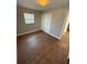 Bedroom features wood-look floors, fresh paint, and a double door closet at 5018 Figwood Ln, Orlando, FL 32808