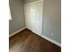 Bedroom featuring wood-look floors, fresh paint, and a double door closet at 5018 Figwood Ln, Orlando, FL 32808