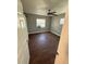 A cozy bedroom with wood-look tile flooring and two windows for natural light at 5018 Figwood Ln, Orlando, FL 32808