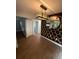 Dining room featuring wood floors, modern lighting fixture, and decorative honeycomb design at 5018 Figwood Ln, Orlando, FL 32808
