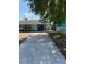 Charming single-story home featuring a well-manicured front yard and a long driveway leading to the entrance at 5018 Figwood Ln, Orlando, FL 32808