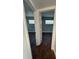 Hallway showing wood-look floors, neutral paint, and access to bedrooms through white doors at 5018 Figwood Ln, Orlando, FL 32808