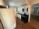 A bright kitchen featuring white cabinets, stainless steel appliances, wood countertops and tile backsplash at 5018 Figwood Ln, Orlando, FL 32808