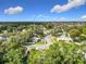 A scenic aerial view of the neighborhood with lush trees and glimpses of waterfront properties at 5240 N Lake Burkett Ln, Winter Park, FL 32792