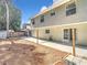 View of the backyard showing a patio area and well-maintained yard at 5240 N Lake Burkett Ln, Winter Park, FL 32792