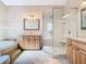 Modern bathroom with a separate shower and tub, complemented by stylish countertops at 5240 N Lake Burkett Ln, Winter Park, FL 32792
