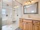 Modern bathroom featuring a large walk-in shower with a built-in bench and a wooden vanity at 5240 N Lake Burkett Ln, Winter Park, FL 32792