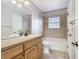 Bathroom features a dual sink vanity, tiled shower/tub, and ample space at 5240 N Lake Burkett Ln, Winter Park, FL 32792