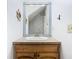 Stylish half bathroom with a mirror above the sink and nautical themed wall decor at 5240 N Lake Burkett Ln, Winter Park, FL 32792