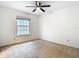 Bedroom featuring a large window and neutral carpeting, providing a cozy atmosphere at 5240 N Lake Burkett Ln, Winter Park, FL 32792