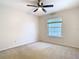 Neutral bedroom with a ceiling fan and natural light from a window with blinds at 5240 N Lake Burkett Ln, Winter Park, FL 32792