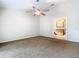 Bedroom with carpet and ensuite bath with vanity and large mirror at 5240 N Lake Burkett Ln, Winter Park, FL 32792
