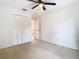 Bright bedroom with a ceiling fan, closet and access to hallway at 5240 N Lake Burkett Ln, Winter Park, FL 32792