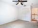 Bright bedroom with a ceiling fan, closet and access to hallway at 5240 N Lake Burkett Ln, Winter Park, FL 32792