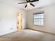 Bright bedroom features a ceiling fan, a window, and an ensuite bathroom at 5240 N Lake Burkett Ln, Winter Park, FL 32792