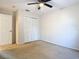 Bedroom with a ceiling fan and a closet featuring louvered doors, providing ample storage at 5240 N Lake Burkett Ln, Winter Park, FL 32792