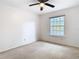 Bright bedroom featuring neutral carpet, a ceiling fan, and a window at 5240 N Lake Burkett Ln, Winter Park, FL 32792