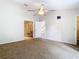 Carpeted bedroom with high ceilings and ensuite bath featuring glass shower at 5240 N Lake Burkett Ln, Winter Park, FL 32792
