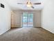 Bright bedroom with carpet, sliding glass doors, and ceiling fan at 5240 N Lake Burkett Ln, Winter Park, FL 32792