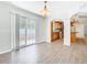 Bright dining area with hardwood floors and sliding glass doors leading to the backyard and open kitchen at 5240 N Lake Burkett Ln, Winter Park, FL 32792