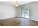 Dining area with hardwood floors and sliding glass doors that offers natural light at 5240 N Lake Burkett Ln, Winter Park, FL 32792