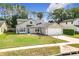 Well-kept home with a neat lawn, tidy landscaping and a welcoming entrance, enhancing its curb appeal at 5240 N Lake Burkett Ln, Winter Park, FL 32792