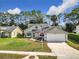 Charming home with manicured lawn, classic design, and an inviting facade in a residential setting at 5240 N Lake Burkett Ln, Winter Park, FL 32792