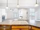 Kitchen island with breakfast bar seating and a double bowl sink at 5240 N Lake Burkett Ln, Winter Park, FL 32792