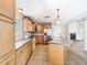 Traditional kitchen featuring wood cabinets, stainless steel appliances, and a spacious center island at 5240 N Lake Burkett Ln, Winter Park, FL 32792