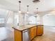 Kitchen island with breakfast bar seating and stainless steel dishwasher at 5240 N Lake Burkett Ln, Winter Park, FL 32792