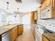 Bright kitchen features wood cabinets, stainless steel dishwasher, and open layout at 5240 N Lake Burkett Ln, Winter Park, FL 32792