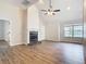 Spacious living room with a fireplace and hardwood floors at 5240 N Lake Burkett Ln, Winter Park, FL 32792