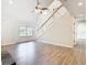 Bright open-concept living room with a fireplace, staircase, and lots of natural light at 5240 N Lake Burkett Ln, Winter Park, FL 32792