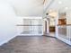 Open loft area with hardwood floors, white railings, and views of the kitchen and living spaces at 5240 N Lake Burkett Ln, Winter Park, FL 32792