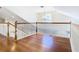 Spacious loft area with hardwood floors, white railings, and natural lighting at 5240 N Lake Burkett Ln, Winter Park, FL 32792