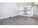 Bright open loft space with wood-look floors and white railings overlooking the lower level at 5240 N Lake Burkett Ln, Winter Park, FL 32792