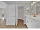 Beautiful bathroom with double doors, white vanity, modern fixtures, and vinyl floors at 1533 Loch Avich Rd, Winter Garden, FL 34787